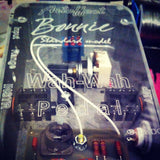 Stack of Dimes inside a wah pedal with see-through bottom plate
